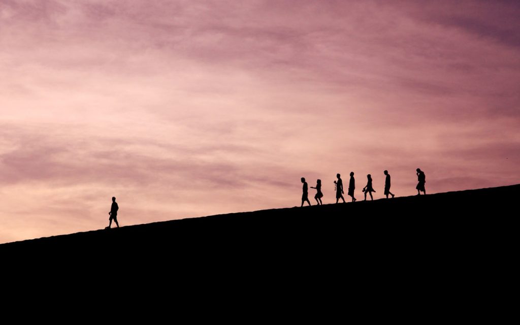 Image of person leading a family in the desert